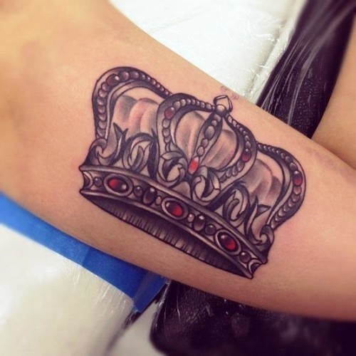 Red and black colored crown tattoo