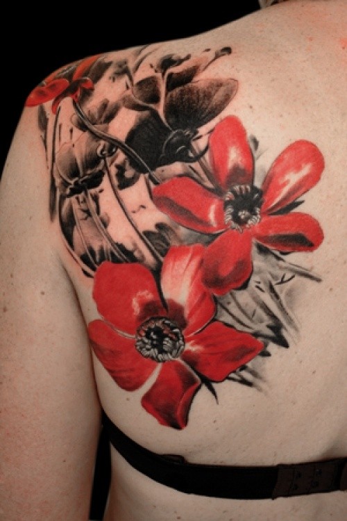Tattoo mit roten und schwarzen Blumen am Schulterblatt