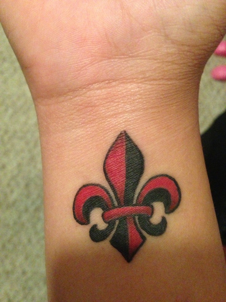 Red black fleur de lis tattoo on wrist