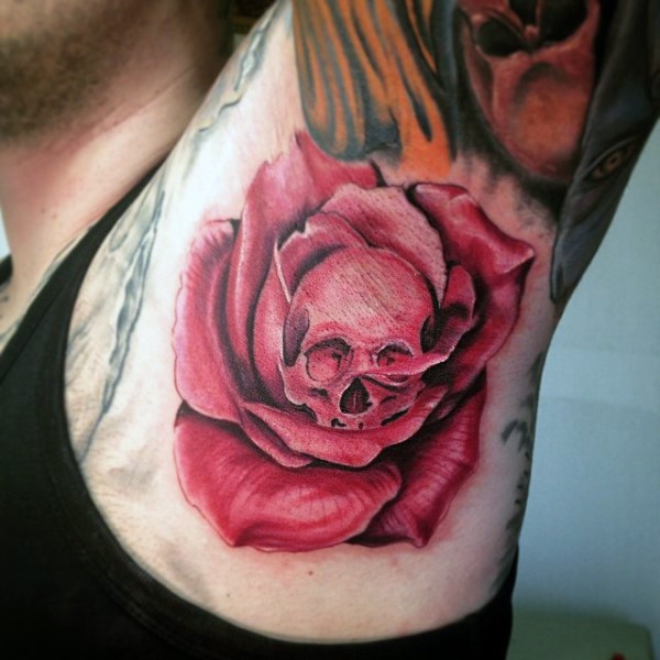 Red colored cool looking rose with skull tattoo on arm