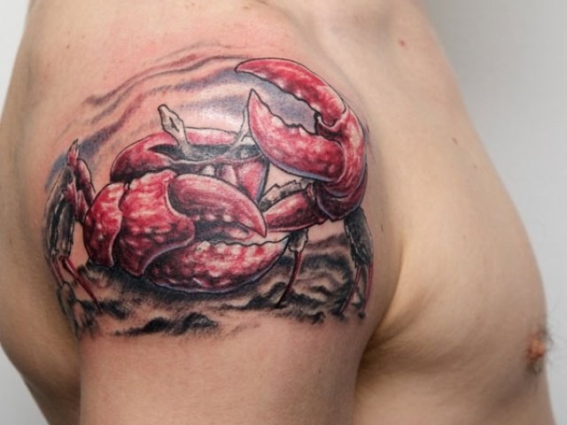 Red crab tattoo on shoulder for male