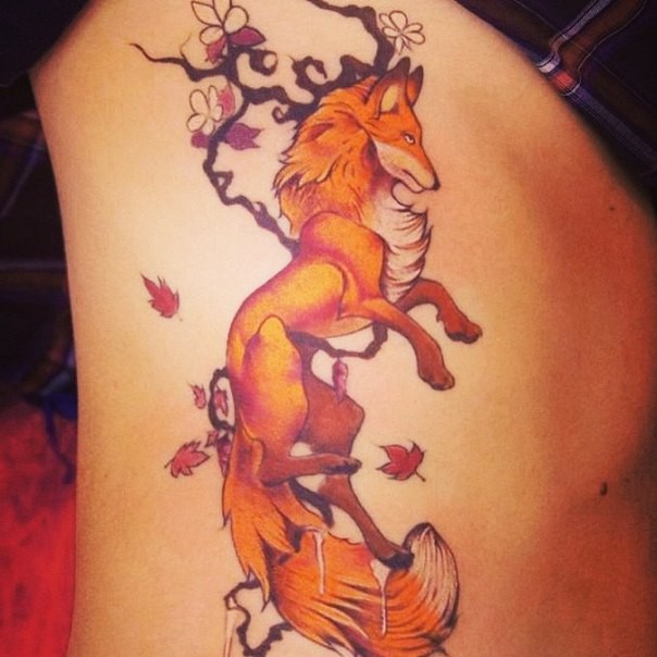 Red fox and tree branch tattoo