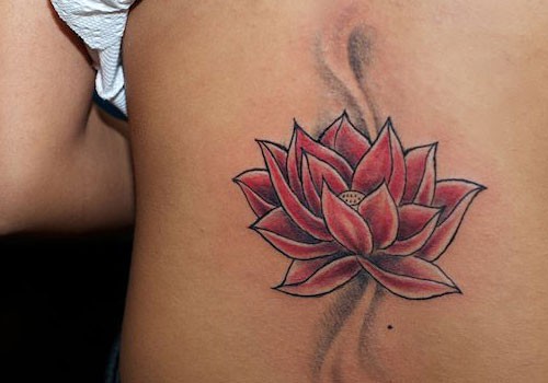 Red lotus flower tattoo on back