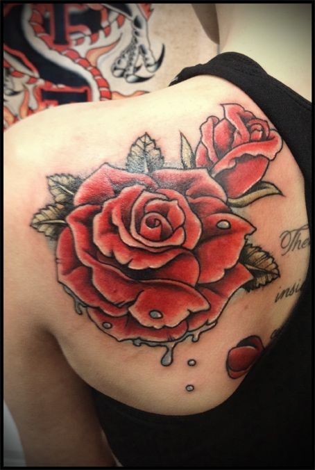 Red roses tattoo on shoulder blade