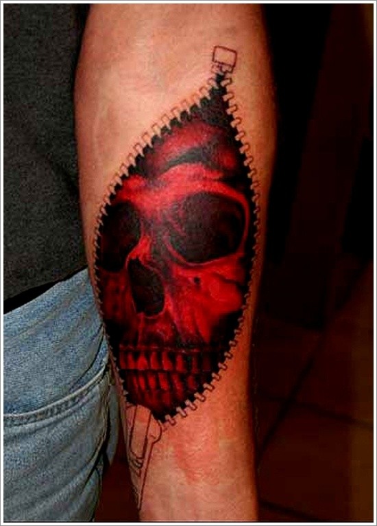 Red skull looks out of skin rip forearm tattoo