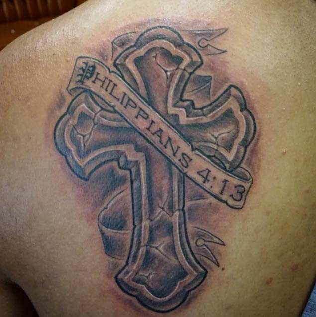 Religious massive ancient cracked cross with banner lettering shoulder tattoo