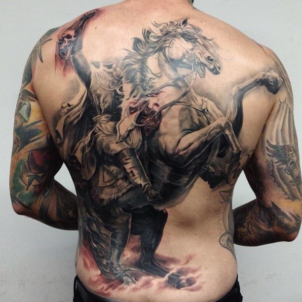Rider on a horse tattoo on back