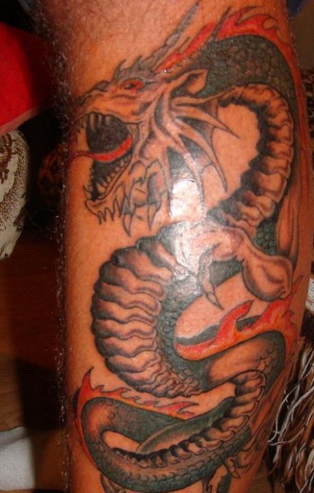 Roaring dragon tattoo on leg
