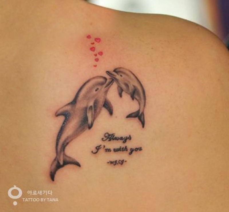 Romantic and sweet colored little dolphins with hearts and lettering tattoo on shoulder