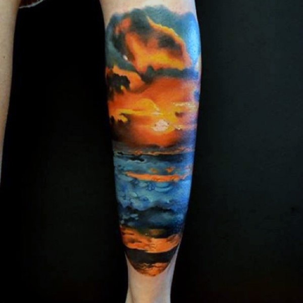 Romantic designed colorful ocean sunset tattoo on leg