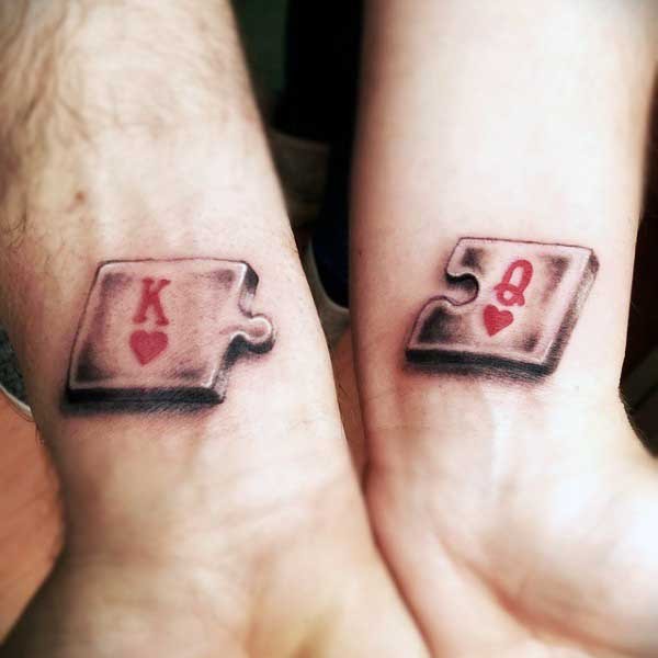 Romantic pair of suitable puzzle pieces with King and Queen of Hearts symbols tattoo in 3D style on both wrists