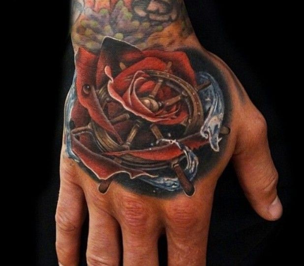 Rose and marine steering wheel tattoo on hand