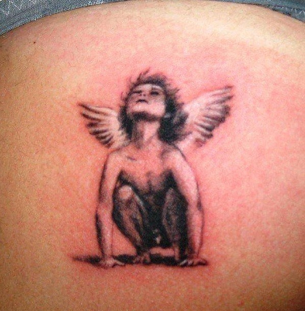 Sad small angel tattoo