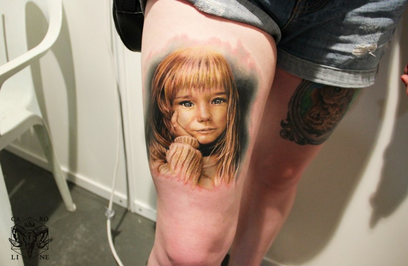 Sensitive child girl lifelike realistic colored portrait tattoo on thigh in realism style
