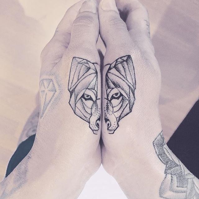 Separated dot style hand tattoo of wolf head