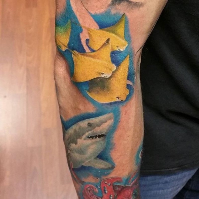 Shark and other sea bottom inhabitants colored arm tattoo with blue shadow