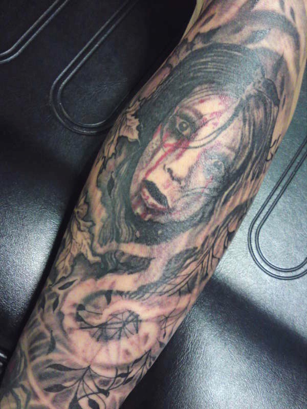 Sharp designed scary girl in mystical fog tattoo on arm