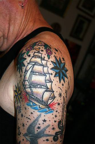 Shoulder oldschool tattoo with ship and stars