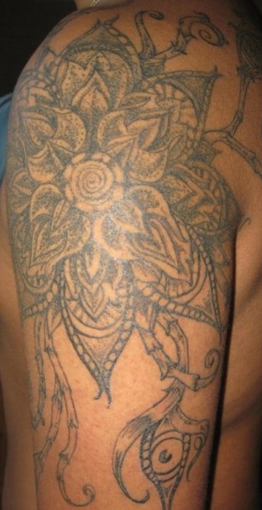 Gran tatuaje en hombro con enigmática flor