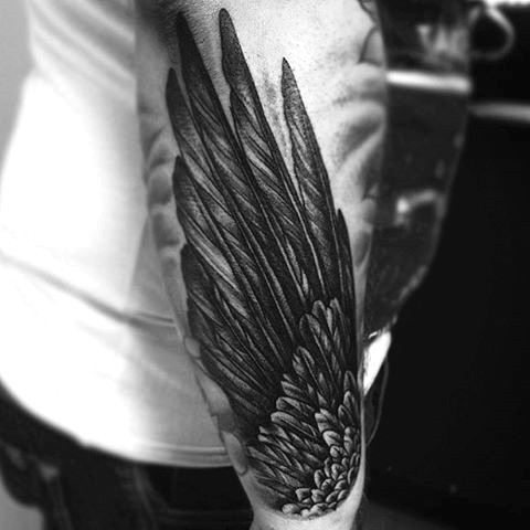 Simple big black ink feather wing tattoo on arm