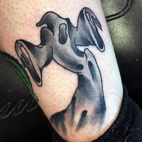 Simple black and white ghost tattoo on ankle