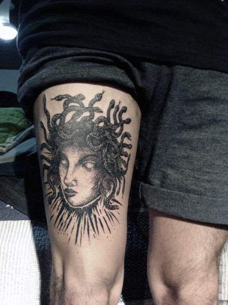 Simple black and white Medusa head tattoo on thigh