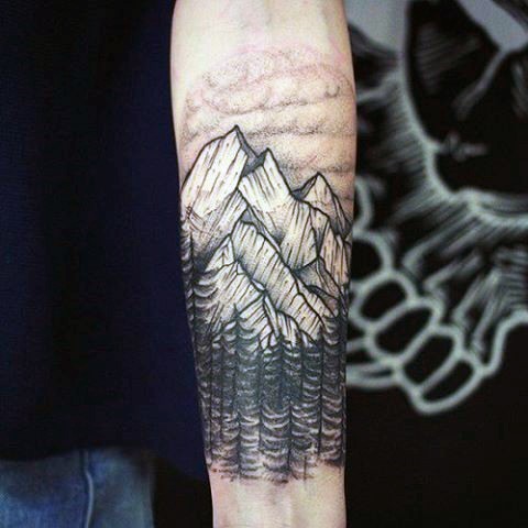 Simple black and white mountains with forest tattoo on arm