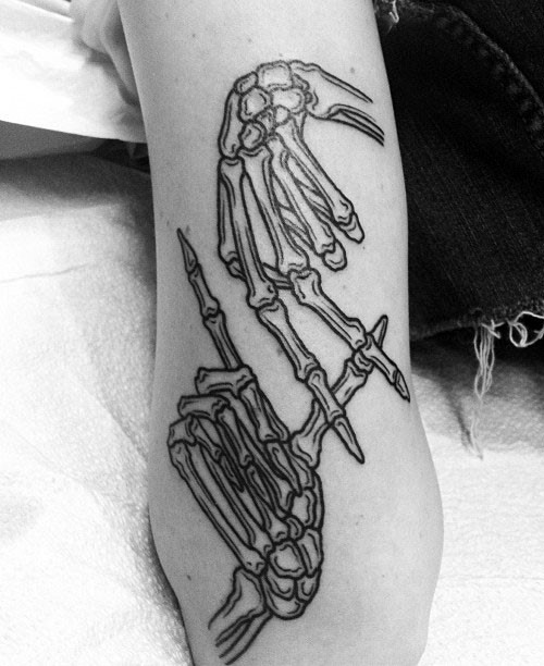 Simple black ink arm tattoo of human skeleton hands