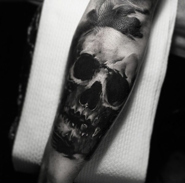 Simple black ink forearm tattoo of human skull