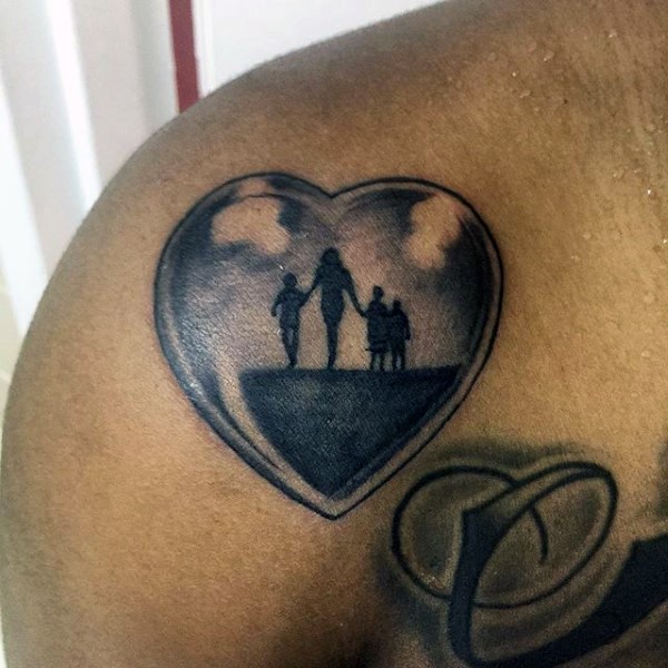 Simple black ink heart stylized with family tattoo on shoulder