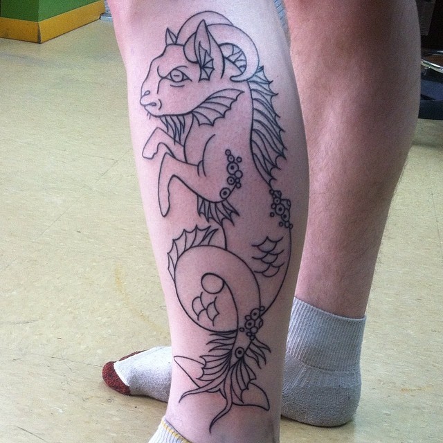 Simple black ink leg tattoo of fantasy creature