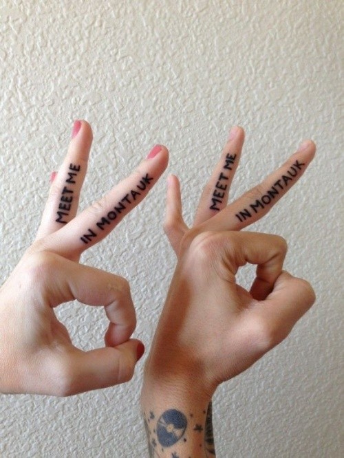 Simple black ink lettering couple tattoo on fingers