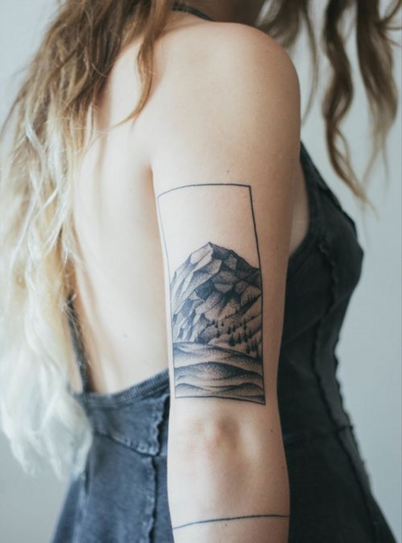 Simple black ink photo like little mountain tattoo on arm