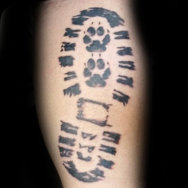 Simple black ink tattoo of human foot print combined with small dag paw prints