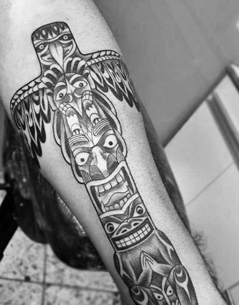 Simple black ink tribal old statue tattoo on arm