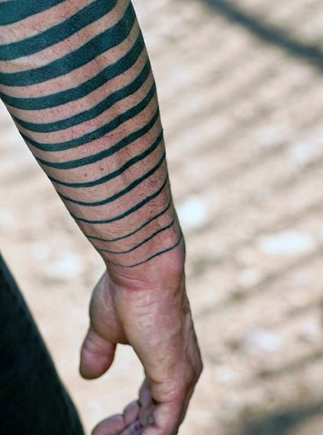 Simple black ink tribal stripes tattoo on arm