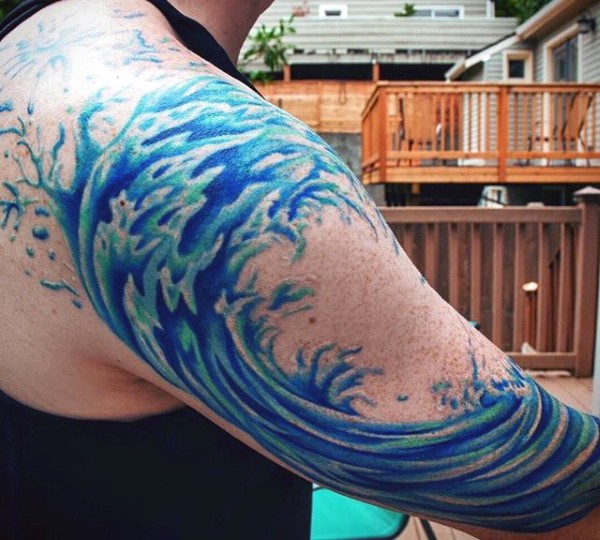 Simple blue colored wave tattoo on shoulder