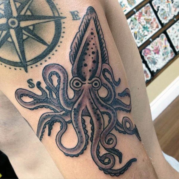 Simple cartoon like colored squid tattoo on arm