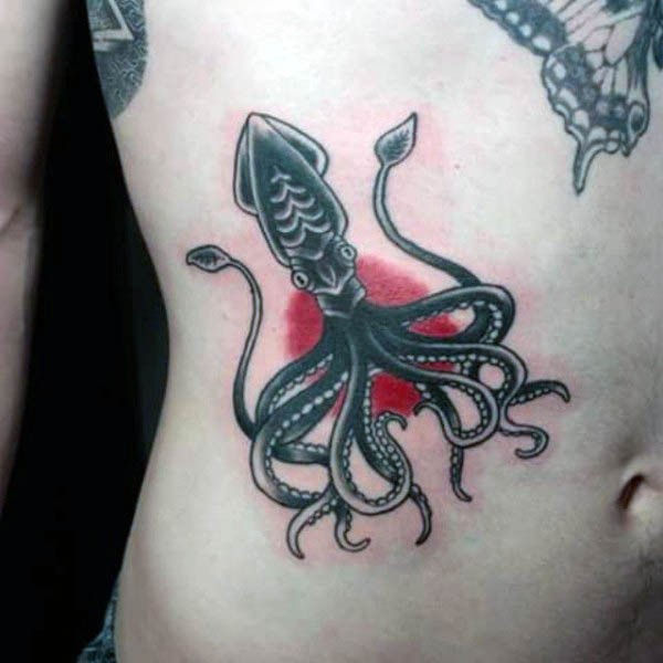 Simple cartoon like painted black and white squid tattoo on side