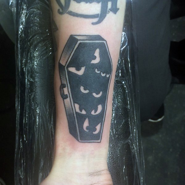 Simple creepy designed black ink coffin tattoo on wrist