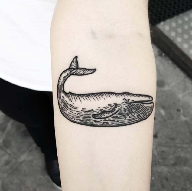 Simple design black and white medium size funny whale tattoo on forearm