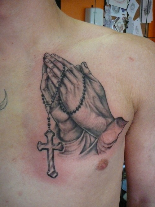Simple designed big black and white praying hands with cross tattoo on chest