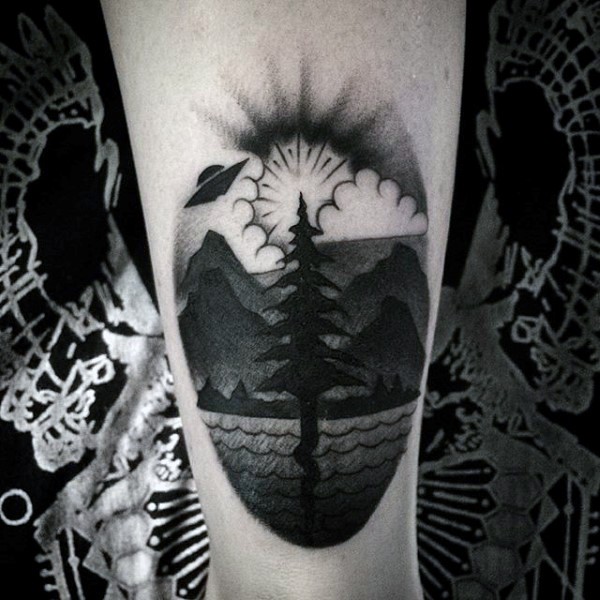 Simple designed big black ink lonely tree with alien ship tattoo on leg