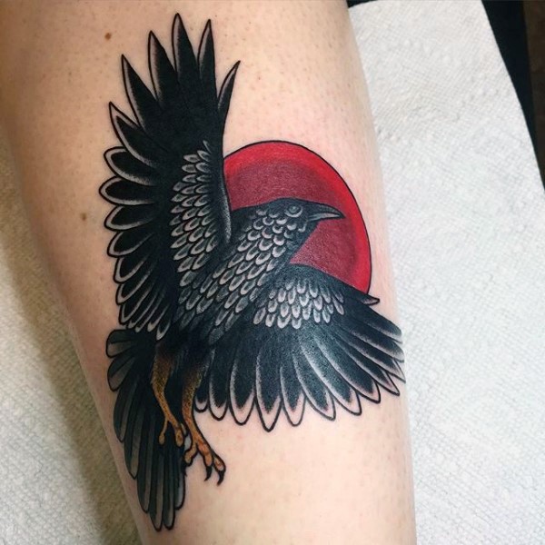 Tatuaje en la pierna, cuervo que vuela y sol rojo oscuro