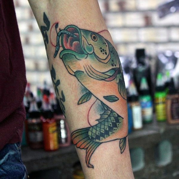 Simple designed colorful hooked fish tattoo on arm