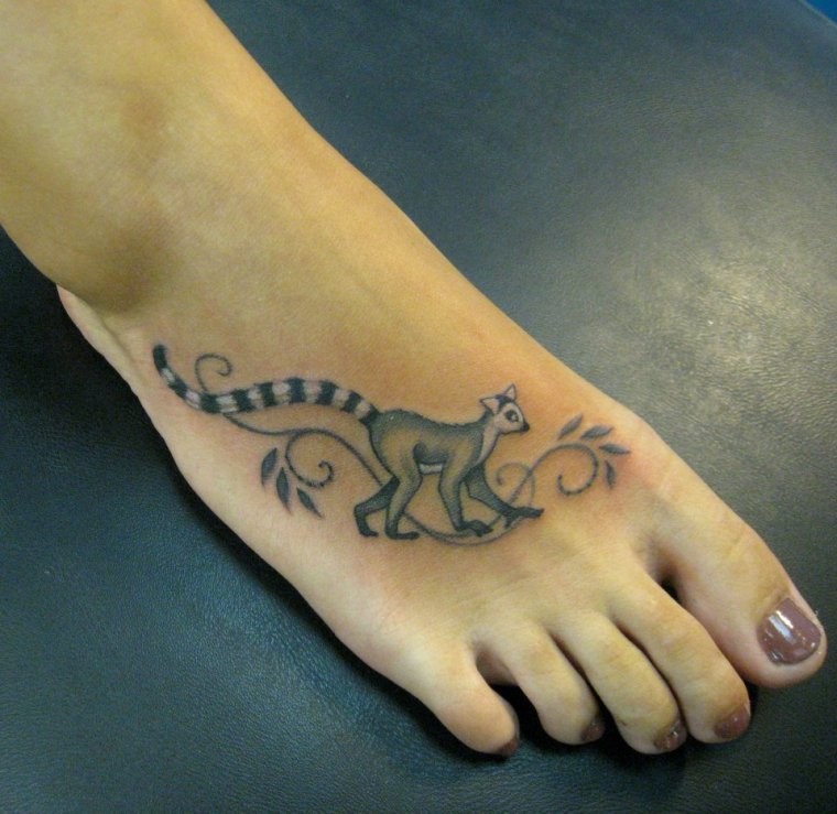 Simple elegant gray-ink lemur tattoo on foot