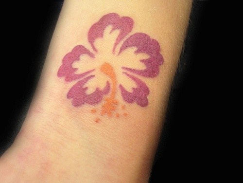 Simple hibiscus flower tattoo on arm