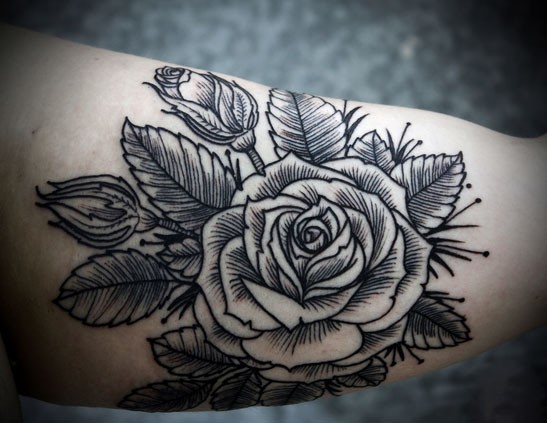 Simple homemade black ink rose tattoo on arm