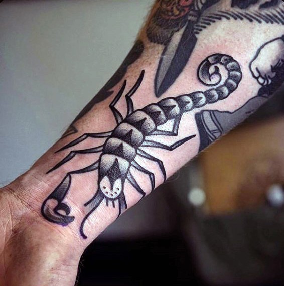 Simple homemade like black ink scorpion tattoo on wrist