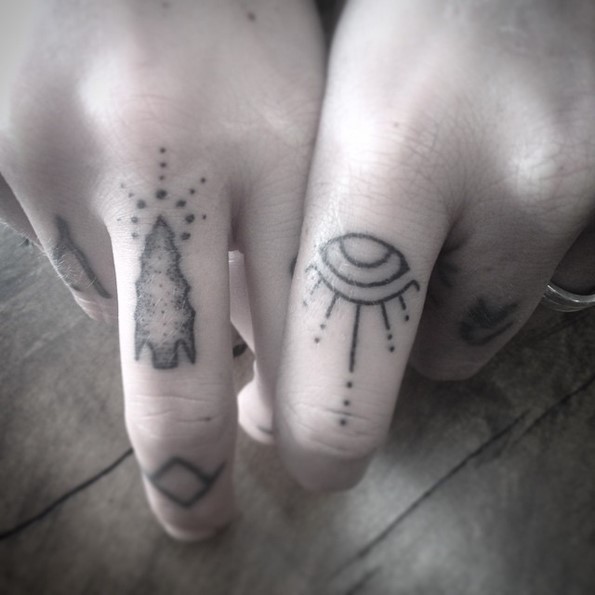 Simple homemade like black ink tribal symbols tattoo of fingers